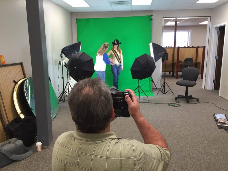 Photography and video production crew filming a rodeo event